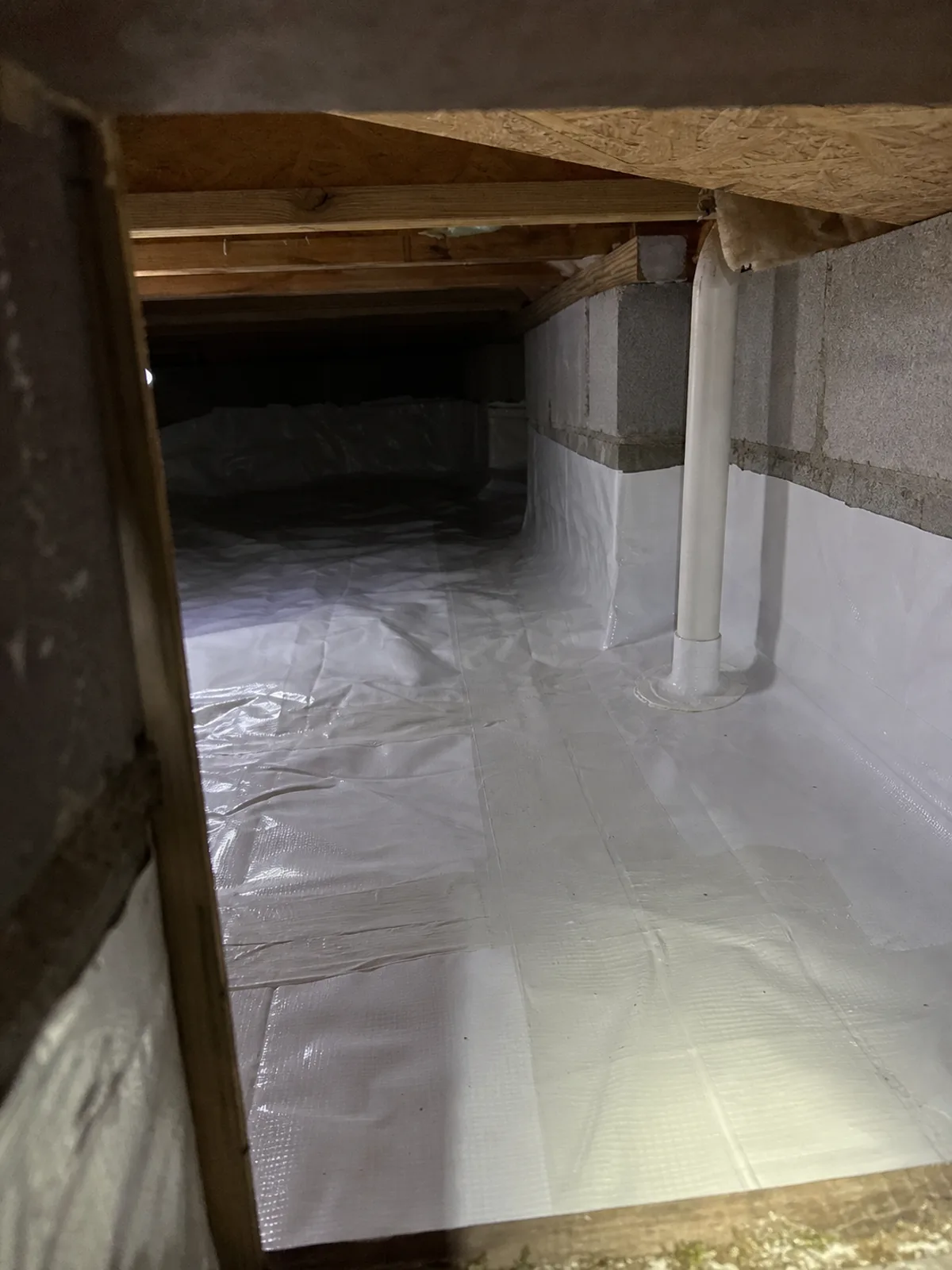 Sealed sub-membrane radon mitigation system in a crawl space